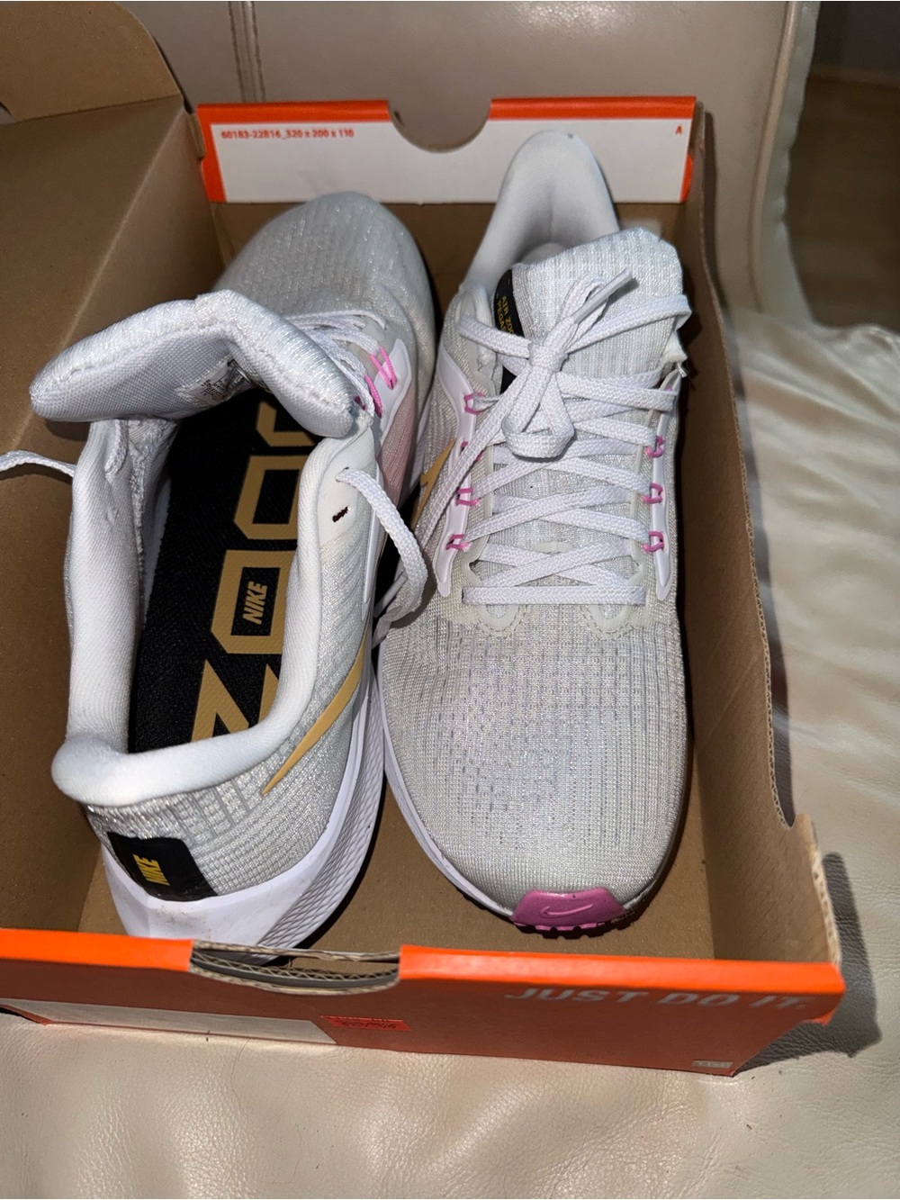 Nike Women’s White Running Shoes with Pink and Gold Accents